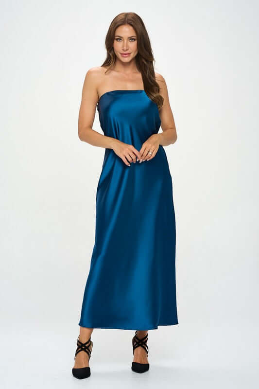 Elegant woman wearing a silky satin tube draped maxi dress in blue, showcasing its sleeveless design and casual to formal versatility.