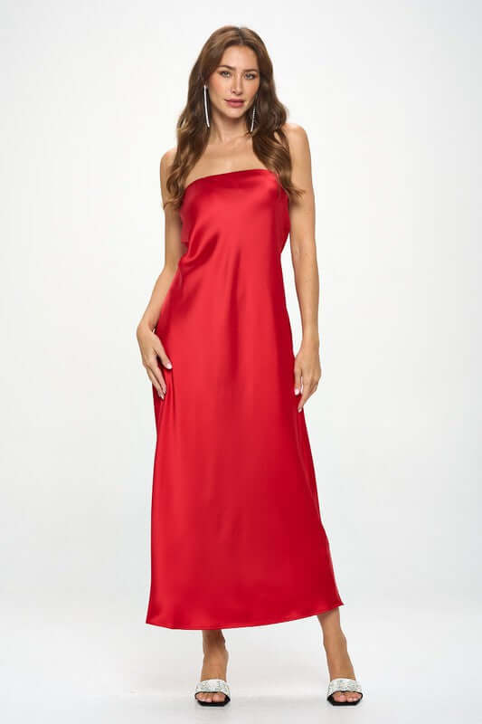 Woman wearing a red silky satin tube draped maxi dress, sleeveless and solid pattern, made in USA, casual or formal style.