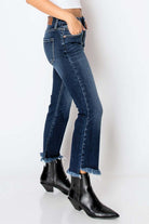 Woman wearing Corset High Rise Crop Flare Jeans with black boots, showcasing a flattering slim fit and frayed hem for casual style.