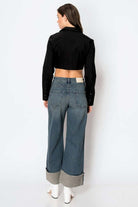 Woman wearing Tummy Control High Rise Cuffed Wide Leg Jeans with hidden pockets and stretch denim, showcasing back view.