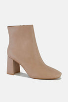 Stylish PU leather block heel boot in beige with a modern design and side zipper for easy wear. Perfect for any outfit.