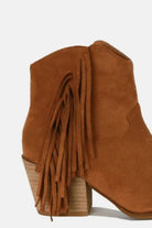 Suede fringe point toe ankle boots with a stylish block heel and playful fringe detailing. Perfect for bohemian outfits.